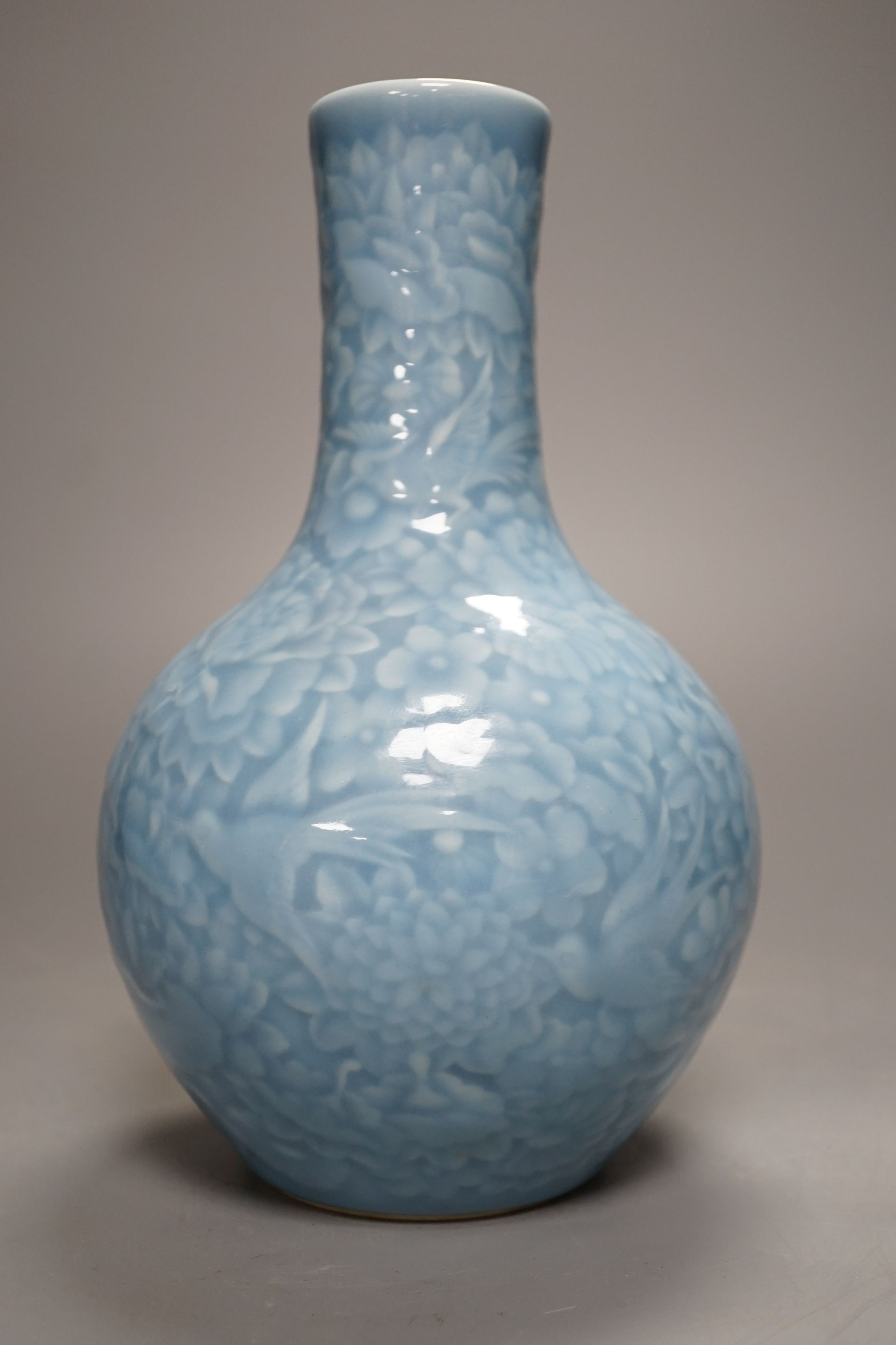 A Chinese blue-glazed moulded bottle vase - 23cm high